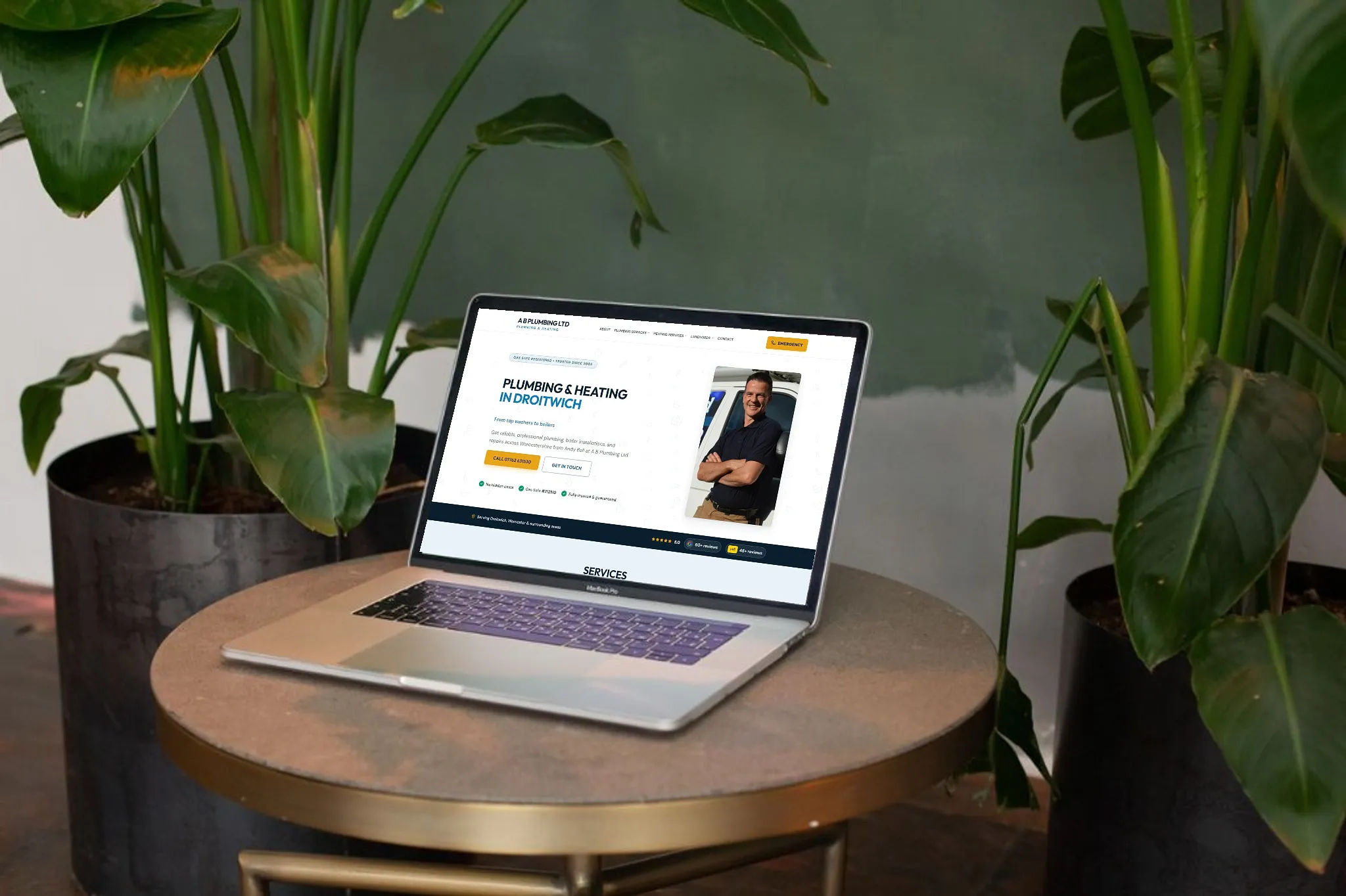 A B Plumbing Ltd website shown on a laptop in a studio setting